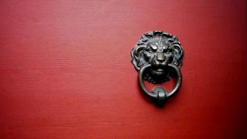 a door knocker is used to knock on a door three times