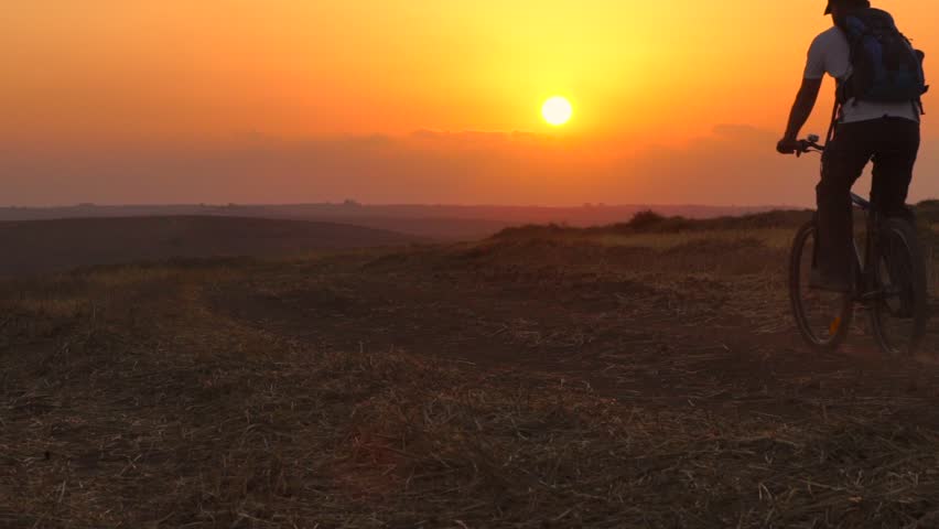 Traveler Riding Bicycle at Sunset, Summer Field - slow motion 60fps
