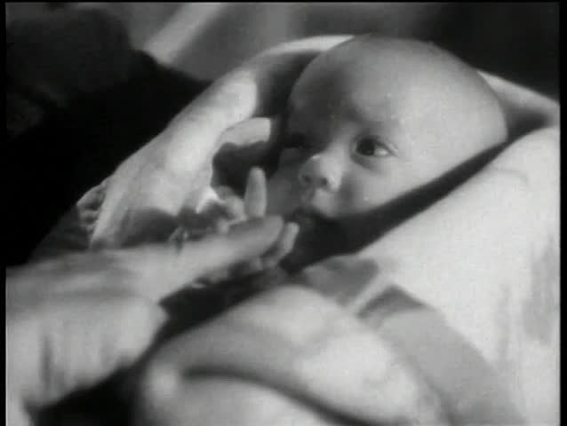 Close-up of infant holding adult hand