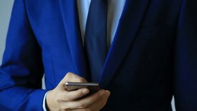 Closeup of Business man using a cellphone with one hand