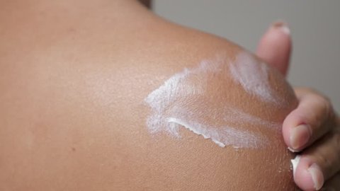Sensual woman spreading body lotion on tanned skin close-up 4K 2160p 30fps UHD footage - Female hand cream applying after sunbathing 3840X2160 UltraHD video