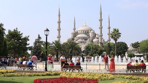 ISTANBUL, TURKEY - JULY 25, 2015 : Tourists visit Blue Mosque in summertime at Sultanahmet Square. Historical Sultanahmet Mosque most famous as Blue Mosque
