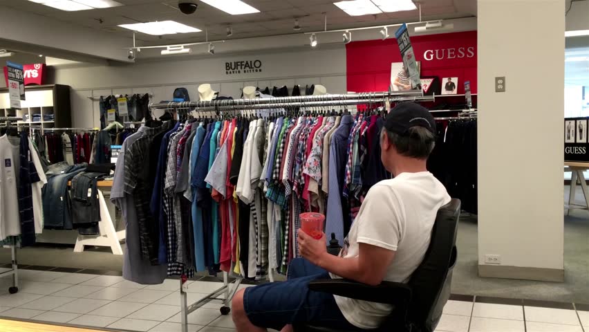 Burnaby, BC, Canada - July 29, 2016 : Man sitting on wheelchair and choosing shirt inside The bay store with 4k resolution | Shutterstock HD Video #18504938