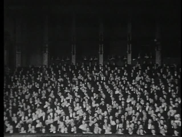 Wide shot of audience in  theater