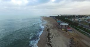 Aerial and bird perspective view from drone of Namibian Atlantic coastline, Swakopmund buildings and beach, surf line and landscape with ocean background of Swakopmund town at Namibia's west coast