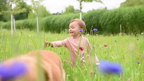 Cute little girl playing in wild flower field