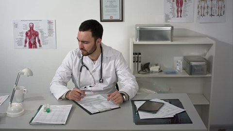 timelapse if doctor working with papers at his desk