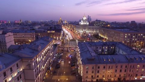 Stalinist high rise building at Mayakovskaya square in Moscow. Beautiful night illumination. Road traffic. Aerial drone flight. 4K footage.