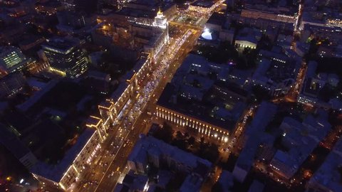 Sadovoe ring evening road traffic. Center of Moscow night illumination. Aerial drone from above view to moving cars. Stalin skyscrapers and modern business centers at background.