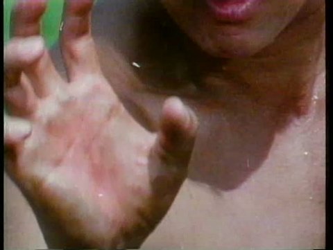 Close-up of barechested man's hand shaking