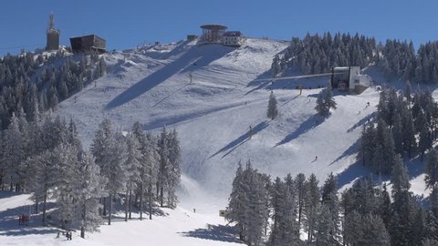 BRASOV - ROMANIA, FEBRUARY 15, 2013, Beautiful mountain resort panorama and ski piste, skier downhill in winter holiday
