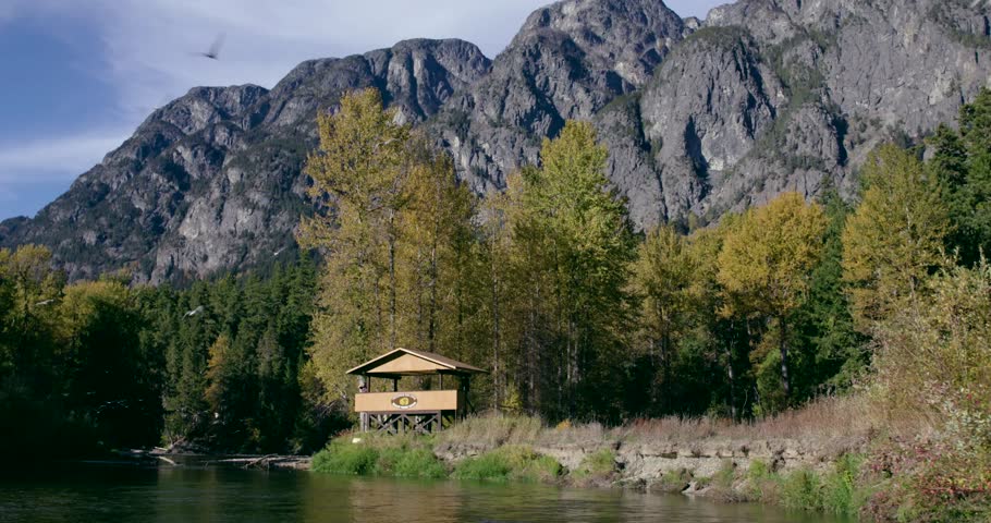 [Dolly shot wildlife viewing station at rivers edge 001]A dolly shot of a wildlife viewing station along the river bank.