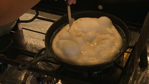 Deep frying a tortilla in hot oil
