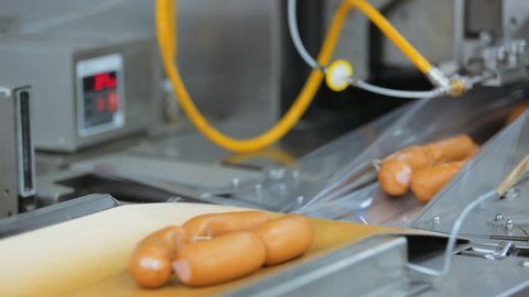 packing sausages on a conveyor belt