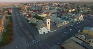 Aerial and bird view drone footage of Namibian Atlantic coastline, Swakopmund historical buildings and landscape with ocean background of Swakopmund town at Namibia's west coast
