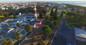 Aerial view drone video of Namibian Atlantic coast, Swakopmund historical buildings and beach, The Lighthouse and landscape with ocean background of Swakopmund town at Namibia's west coast