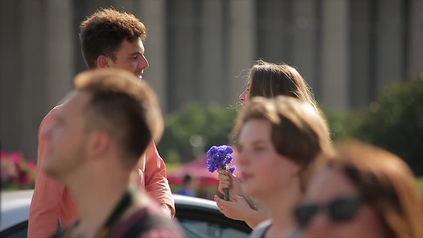 Young Couple Quarrel at a Date (Slow Motion). Woman Returns Flowers to her Boyfriend, and Goes Away