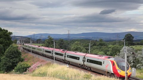 HACKTHORPE, ENGLAND - AUGUST 6:  A Virgin Pendolino heads north through Hackthorpe, Cumbria on August 6, 2016.  Virgin trains have operated the UK west coast main line rail franchise since 1987.