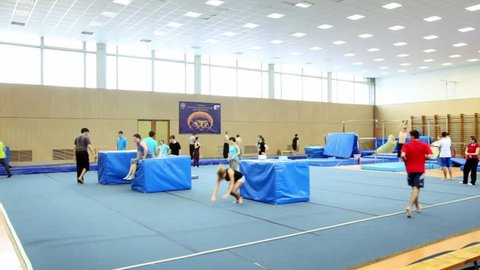 Many young people practice in light gymnasium, cornerview
