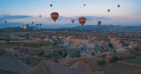 4K Aerial view of Goreme. Colorful hot air balloons flying over the valleys on July 2016, Famous city Cappadocia, Turkey.