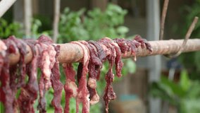Dried raw meat hanging on the wood, thailand food,