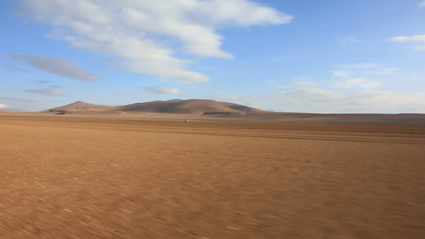 Panoramic view of bolivian altiplano with moving car, Bolivia