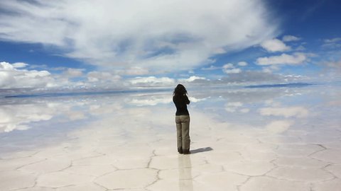 Woman taking pictures in the middle of the lake Salar de Uyuni, Bolivia