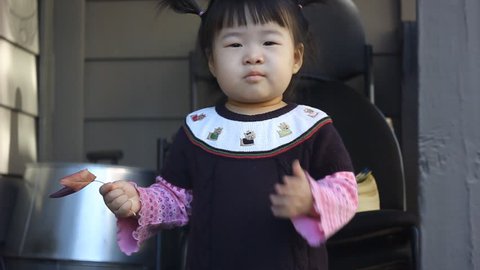 Beautiful Asian Toddler Baby Girl on Wooden Porch Standing