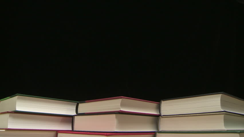 Time lapse of a growing stack of hardcover books