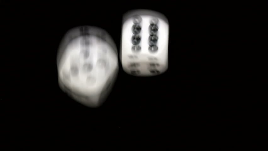 Rolling dice in slow motion with numbers five and six
