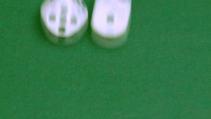 Rolling dice in slow motion with numbers two and three