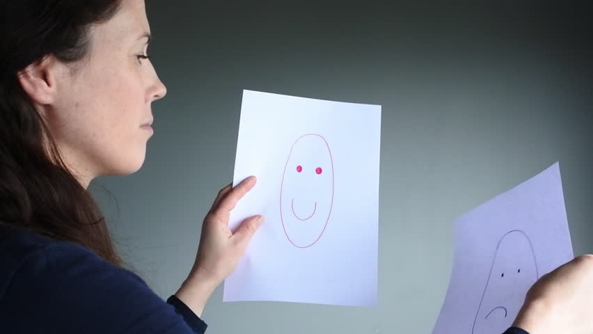 Young woman (age 30-35) choosing between happiness and sadness.Woman lifestyle 