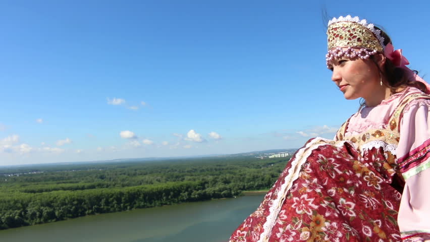 The girl in the dress looks into the distance