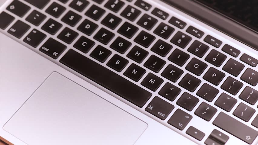Woman or man throws the Polish money banknotes on keyboard of laptop computer. Close up of bills zloty and notebook.