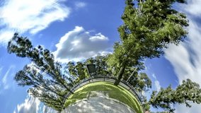 Tiny Little Planet 360 Degree of Taras Shevchenko Prospectus in Kiev, Ukraine. Time Lapse. Blue Sky and White Floating Clouds. High Glass Modern Buildings Along the Road. People Are Passing by Bench