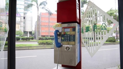 TAIPEI, TAIWAN - MAY 10, 2016: Public telephone booth on sidedwalk Ximendind Taipei, Taiwan.