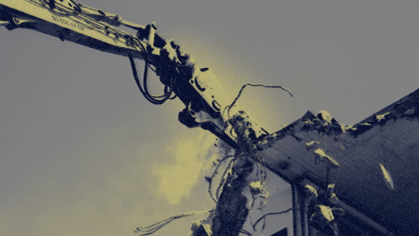a crane breaking down a building, looking a bit like like a dinosaur eating!