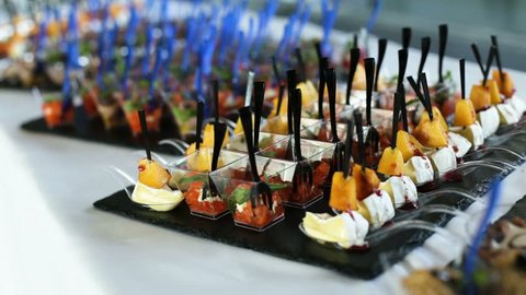 Man grabs appetizers from a cocktail hour spread.