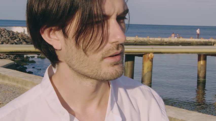 Alone rich man walk at the sea and waiting for friends which should arrive on the yacht