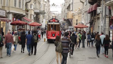 Istanbul, Turkey - May 20, 2016: Nostalgic tramway passing through Istiklal Street. This popular street is actually closed to traffic except this old street car.