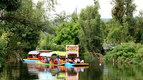 Mexico City, Mexico, July 16. Tourists taking  a ride on brightly colored boats that are similar to gondolas at the Xochimilco park in Mexico City. The park is a UNESCO World Heritage Site.