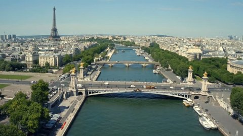 Aerial view of Paris, France with Seine River and Eiffel tower in background.