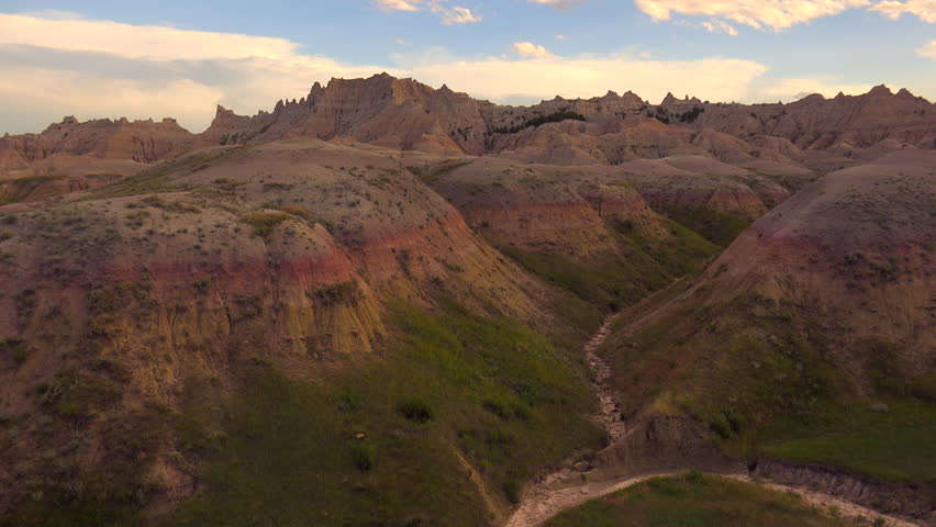 Time Lapse, Clouds lazily glide above colorful mountainous landscape in Badlands National Park, South Dakota in late afternoon. 4K UHD 3840x2160