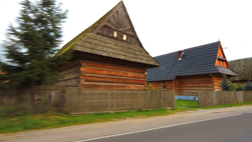 Picturesque Chocholow, one of the oldest highlander village with wooden houses, shot from moving car, Poland
