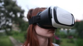 Young woman uses VR helmet with head mount display