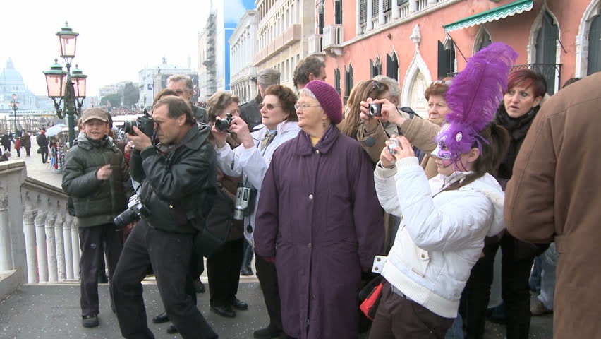 VENICE, ITALY - FEBRUARY 24 2009 four disguised colorful women with a bunch of