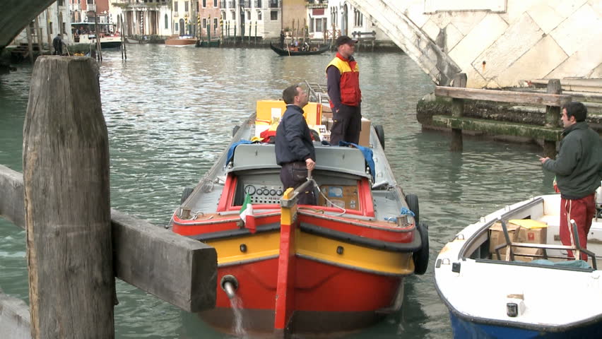 VENICE, ITALY - FEBRUARY 24 2009 Postman on a boat on the Canale Garnde 24th of