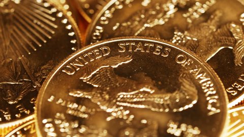 4K macro video with close up of the words United States of America on a rotating gold eagle US mint coin representing safe investment or return to gold standard
