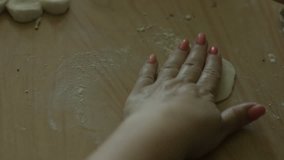 Woman rolls the dough into a kitchen, roller dough stosk video footage