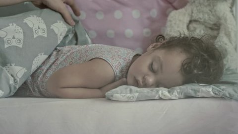 Beautiful mother with her 16 months old baby sleeping, slow motion clip